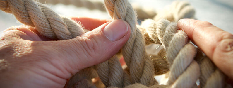 Natural,Hemp,Rope,Being,Knotted,By,A,Sailor/fisherman,,Close,Up